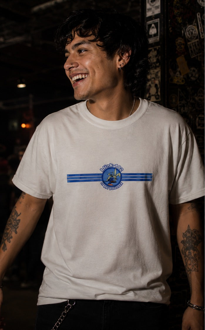 Model wearing the white Blink-182 Crappy Punk Rock T-shirt in a punk rock venue