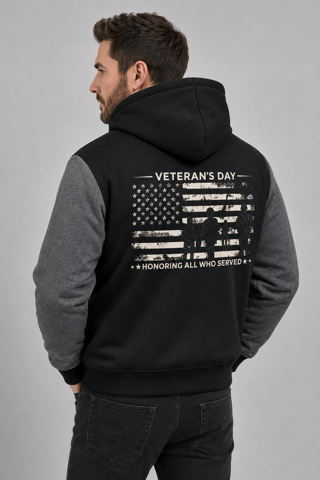 Adult model wearing Veterans Day Honoring All Who Served black and gray fleece jacket, three-quarter back view