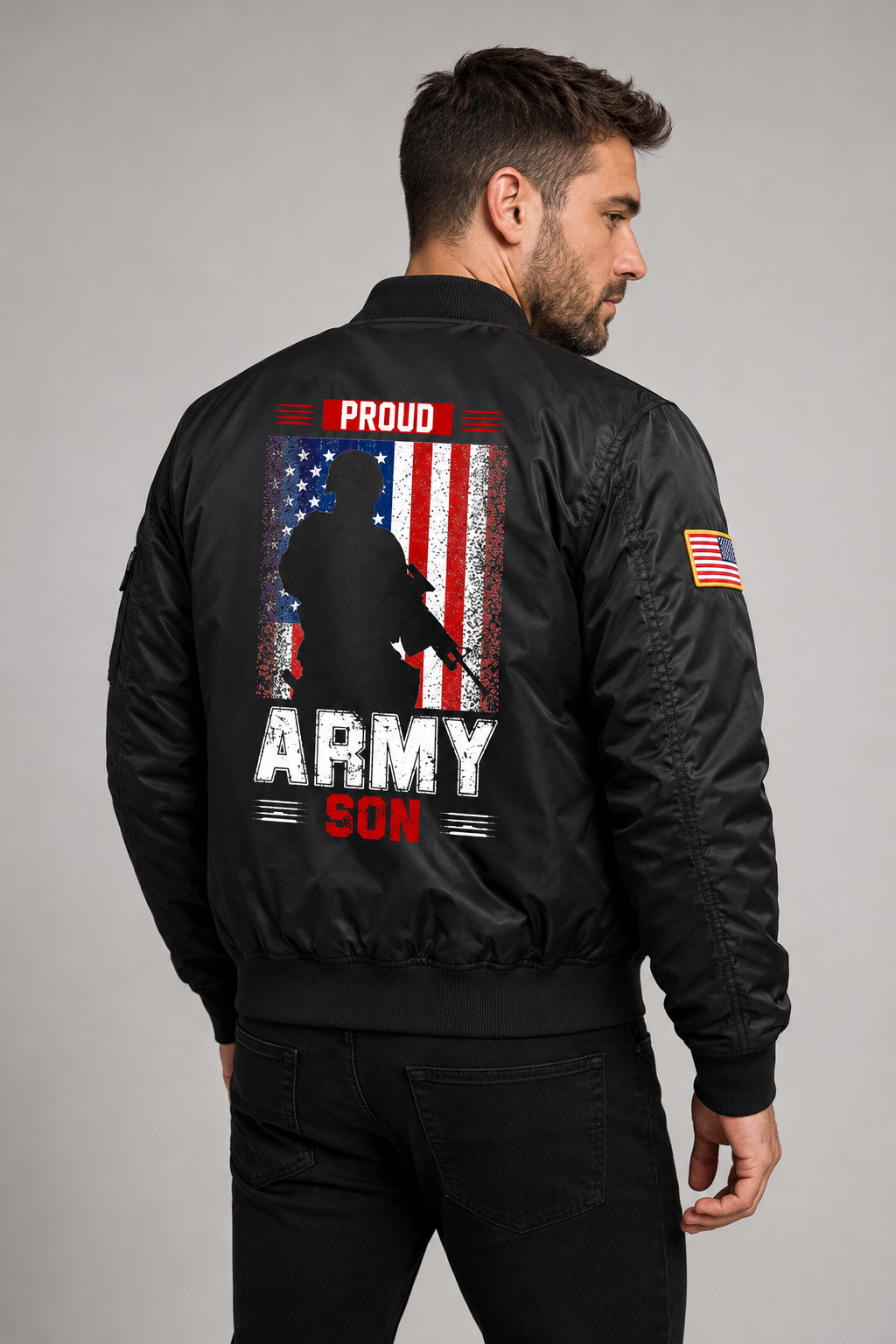 Adult model wearing Proud Army Son American Flag black bomber jacket, three-quarter back view