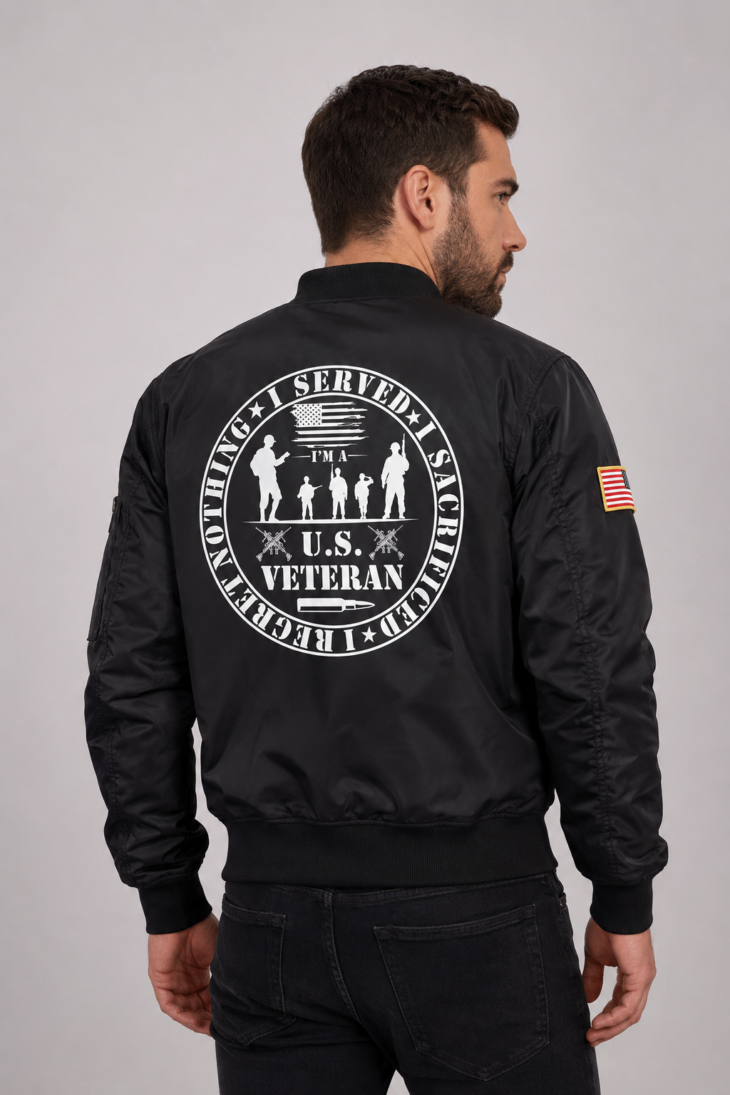 Adult model wearing U.S. Veteran Service Badge black bomber jacket, three-quarter back view