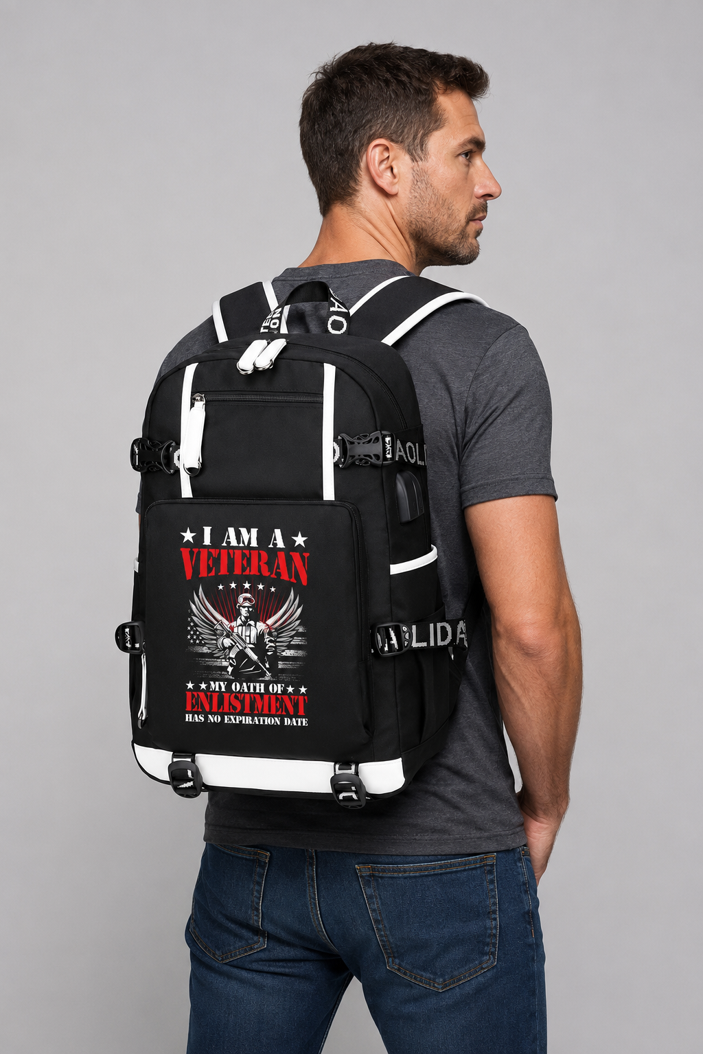 Adult model wearing I Am a Veteran Enlistment Eagle black backpack, three-quarter rear view