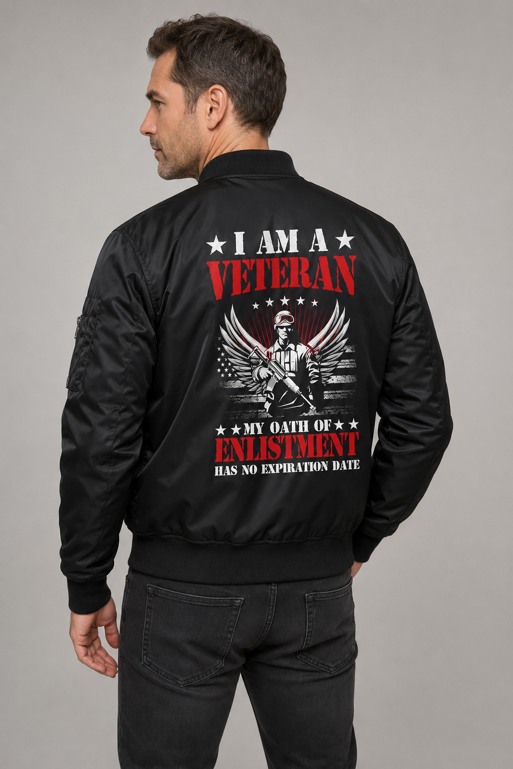 Adult model wearing I Am a Veteran Enlistment Eagle black bomber jacket, three-quarter back view