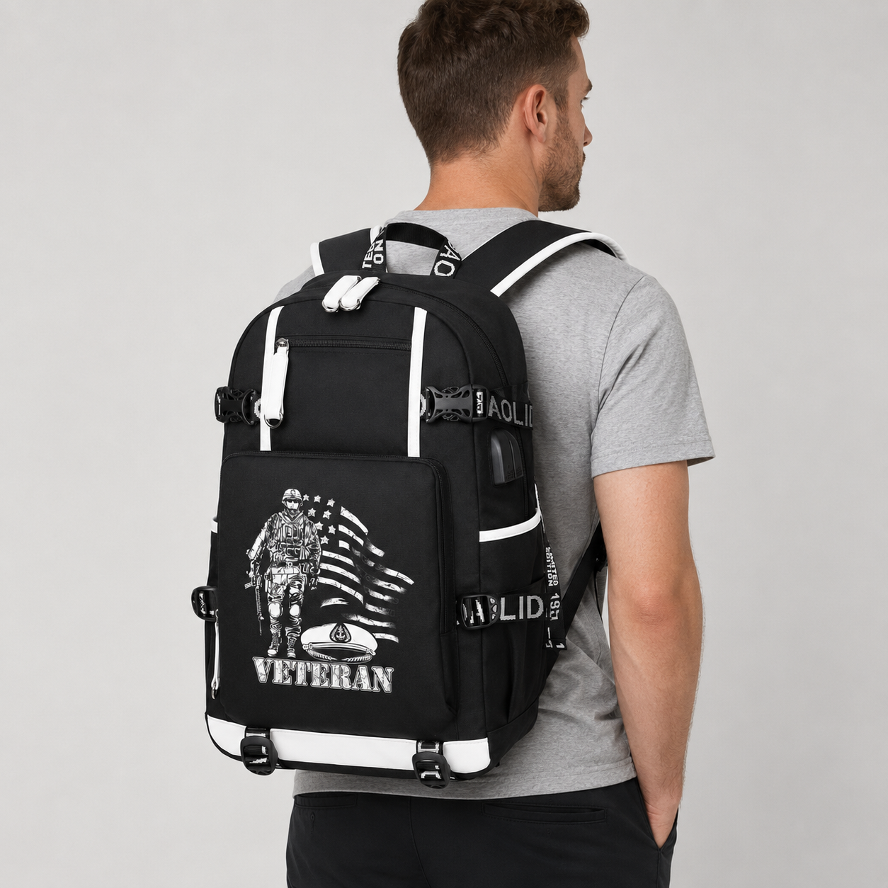 Adult model wearing American Flag U.S. Veteran black backpack, three-quarter rear view